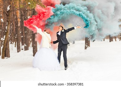 Wedding Couple With Color Smoke In The Winter Park. Colour Bomb