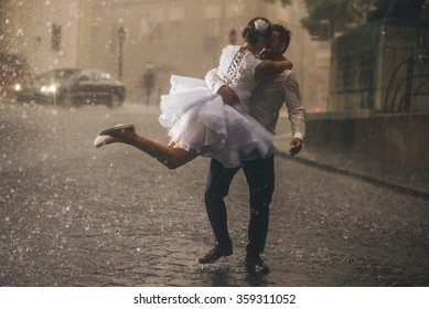 wedding couple dancing in the rain