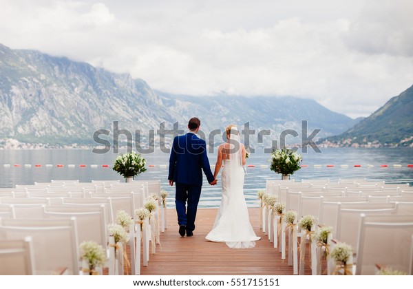 wedding couple\
at destination wedding ceremony. Mountains and sea view in\
Montenegro. Picturesque wedding\
location.