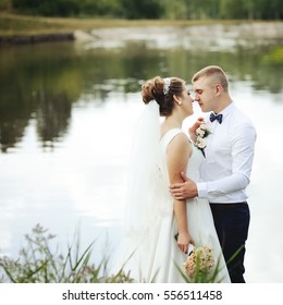 wedding couple, groom and bride by the lake at countryside
