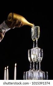 Wedding Couple Hands Pouring Champagne To A Wine Glass Pyramid