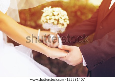 Wedding couple holding hands