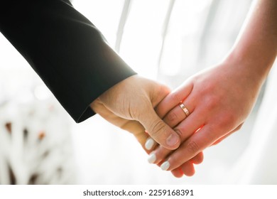 Wedding couple holding hands, groom and bride together on wedding day - Shutterstock ID 2259168391