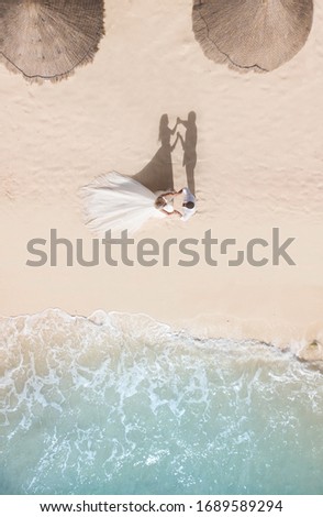 Wedding couple on a beach, drone top-down shoot