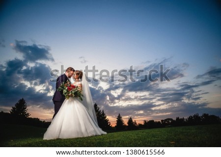 wedding couple in the park; bride and groom; love of two people; the bride holds a beautiful bouquet; wedding photography;  Wedding Dress
