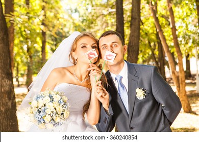 Wedding Couple Posing With Stick Lips, Mask