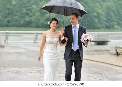 Wedding Couple In A Rainy Day