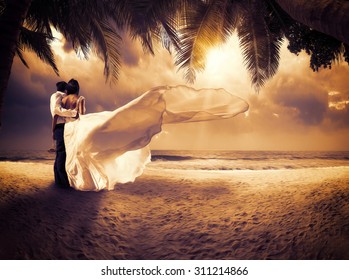 Wedding Couple With The Sunset On The Tropical Beach