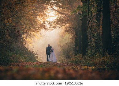 Wedding Couple Together In Autumn Forest