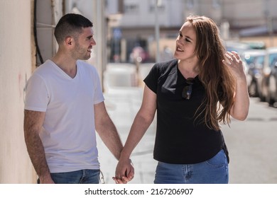 wedding couple walking down the street holding hands