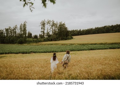 Wedding Couple Walking In Wheat Field.