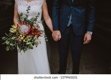 Wedding couple where the bride is holding a large bouquet of flowers on their wedding day - Shutterstock ID 1379965031