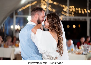 Wedding Dance. The Bride And Groom Dance In Front Of The Guests At The End Of The Festive Dinner. Traditions. Beautiful, Happy And Tired Newlyweds.