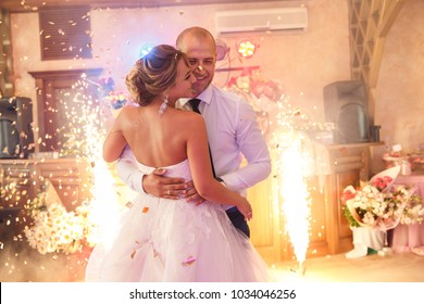 Wedding Dance Of Bride And Groom With Special Effects- Colorful Smoke And Fireworks. Newlyweds Couple Dancing At Wedding Day. Marriage And Wedding Party Concept