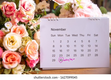 Wedding Date Anniversary Calendar And Flower Bouquet (rose). A Couple Of Love Planning A Honeymoon Next Month.