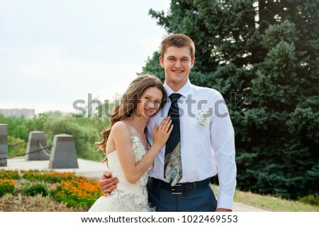 Wedding Day. Beautiful Bride in White Dress with Groom. Happy Couple in the Park.