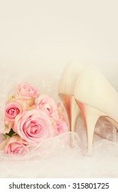 Wedding Day concept with roses and bridal shoes.