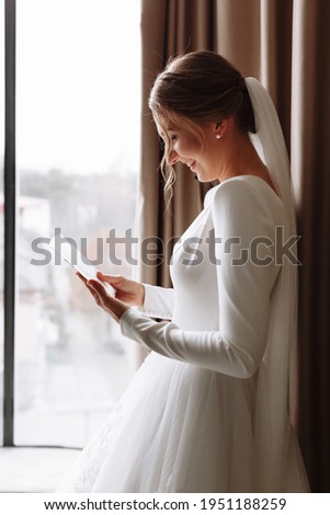 Wedding day. Fees at the hotel. the bride near the window and reads the letter to the groom. Wedding vows. Preparations. Morning of the bride. bride in white dress and veil