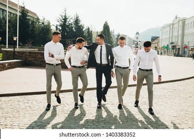 Wedding. Wedding day. Groom with groomsmen walking after wedding ceremony. Handshakes. Groom with friends at wedding day 