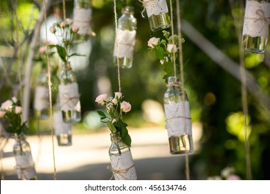 Wedding Decor, Bottles With Flowers On Green Background