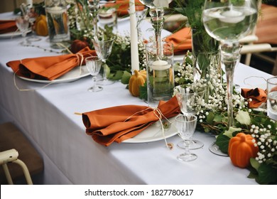 The Wedding Decor Rustic Style. Table Decoration Setting with Flowers Ivy and Pumpkins. 