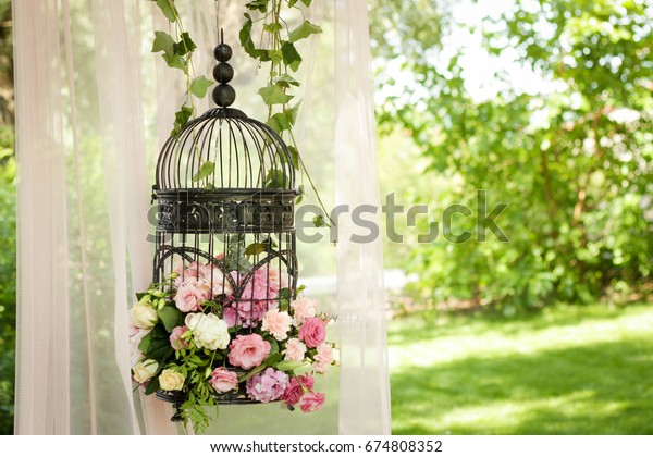 Wedding decor, decor in the trees, flowers in black cages
