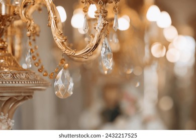 Wedding decoration with antique crystal chandeliers with candles. Glass pendants in the form of balls.  A light bulb in the shape of a candle