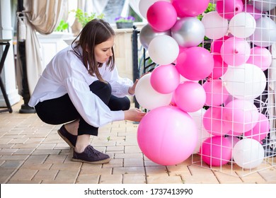 Wedding decoration. Birthday party. Young woman decorates an evening party. Decoration for a children's entertainment. Birthday decoration. First birthday. Decoration with balls.  - Shutterstock ID 1737413990