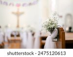 wedding decoration inside a church with white flower and veil