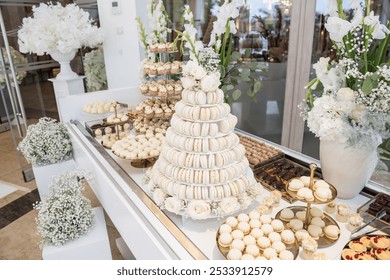 Wedding decoration with pastel colored cupcakes, meringues, muffins and macarons. Elegant and luxurious event arrangement with colorful cakes. Wedding dessert  - Powered by Shutterstock