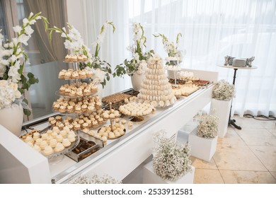 Wedding decoration with pastel colored cupcakes, meringues, muffins and macarons. Elegant and luxurious event arrangement with colorful cakes. Wedding dessert  - Powered by Shutterstock