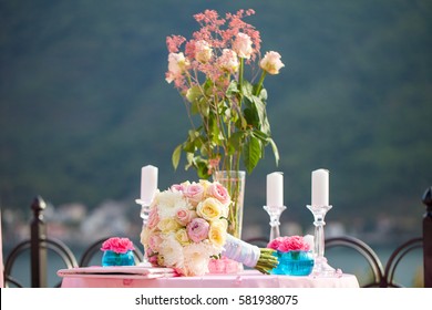 Wedding decoration table with bridal bouquet and candles