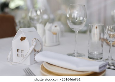Wedding decorations made of white flowers and candles. Setting the table for the bride and groom