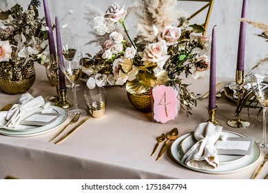 wedding decorations. Served wedding table with decorative  fresh fresh flowers and dried flowers. celebration details. flower composition roses plates and candles in candlesticks