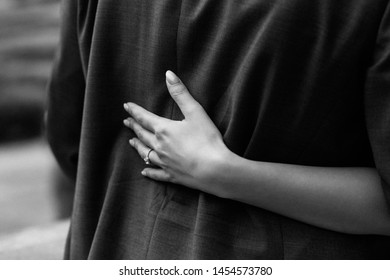 Wedding detail close up. Sensual moment. Hand of bride with gold wedding ring in wedding day. Just married couple. Bridal couple hugging. Black and white. 