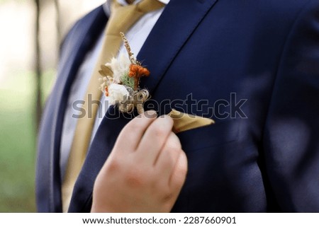 Wedding details. Close-up of groom's boutonniere. Selective Focus
