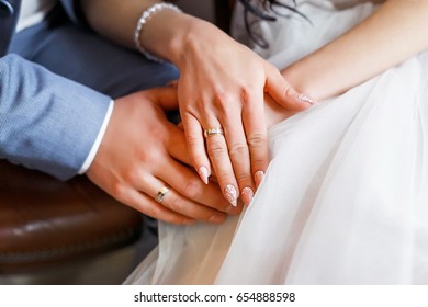 Wedding details. Hands of the newlyweds. Bride rings on hands.