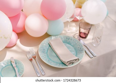 Wedding Dinner Table Reception. Blue Plates With A Pattern And A Napkin, On A Cream Tablecloth. Little Balloons On The Table. Serving A Table For A Bachelorette Party.