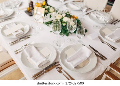 Wedding Dinner Table Reception. The Cream Sheet Of The Menu Is In A Plate With A Cloth Napkin. Cutlery Laid Out According To The Rules Of Etiquette. Top View 