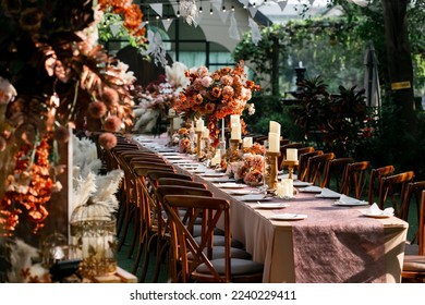 Wedding dinner table reception at sunset outside, wooden chair in wedding