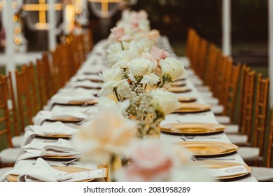 Wedding dinner table setup and decorations with gold Tiffani chair and gold plates