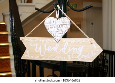 Wedding Direction Board At The Top Of The Stairs Showing The Way To The Wedding Ceremony With A Love Heart Sign Placed Above. 