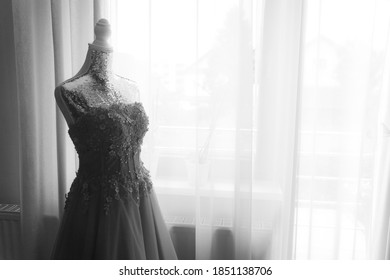 Wedding dress on a mannequin at home next to a big window - Powered by Shutterstock