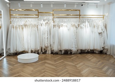 Wedding dresses in store. wedding dresses hang in a row on hangers. - Powered by Shutterstock