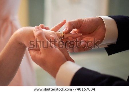 wedding, dressing wedding ring on finger close-up