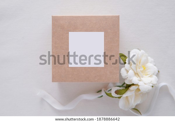 Wedding favor box and sticker\
mockup, blank square tag , card or sticker on gift box for design\
presen 