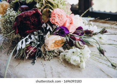 Wedding Floristry. A Bouquet Of Flowers And Greenery Lies On A Granite Window Sill