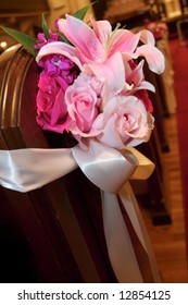 Wedding Flowers In A Church On The End Of A Pew