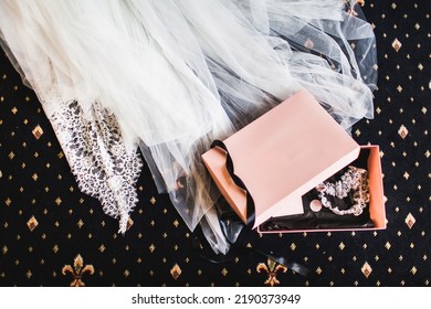 Wedding Garter In A Pink Box On The Floor.