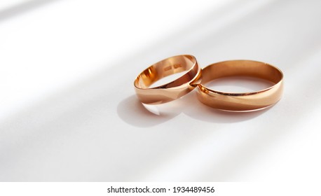 Wedding gold classic rings on a white background. wedding preparations. close-up, macro. - Powered by Shutterstock